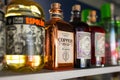 Selection of alcohol bottles on the bar shelf.