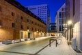 Historic architecture next to the modern architecture of Granaries Island in Gdansk at night.