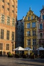 Architecture of the old town with historical buildings and an open-air cafe in Gdansk, Poland Royalty Free Stock Photo