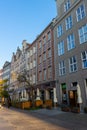 Old street with historic, colorful buildings and different establishments in Gdansk, Poland