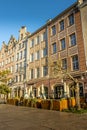 Old town with historical buildings and open-air cafe against a clear blue sky in Gdansk, Poland Royalty Free Stock Photo