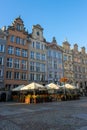 Old town with historical buildings and open-air cafe against a clear blue sky in Gdansk, Poland Royalty Free Stock Photo