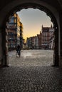 Big city gate called Green Gate at morning with cyclist behind