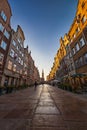 Beautiful long and old Dluga street with old buildings on both sides and beautiful and high red