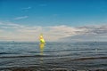 Sailing boat in sea of Gdansk, Poland. Sailboat with bright sail sailing on water on blue sky. Summer adventure and Royalty Free Stock Photo