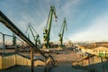 Gdansk, Poland - 05.06.2017: Ship loading cranes old port of Gdansk by Baltic sea. Beautiful Industrial scene in golden