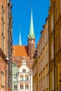 Pointed towers of St. MaryÃ¢â¬â¢s Basilica - Bazylika Mariacka - in back of Kramarska street in the historic old town city center Royalty Free Stock Photo