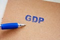 The GDP inscription on note. Word GDP on paper message. gross domestic product