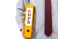 GDPR compliance. Manager holding a folder on white background, text GDPR, clipping path Royalty Free Stock Photo