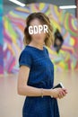 GDPR - woman hiding her face with an inscription General Data Protection Regulation.