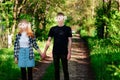 Gdpr, young man holds hand of his girlfriend outdoor at the park, couple standing on the road