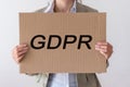 GDPR. A young woman is hidden behind the inscription General Data Protection Regulation.