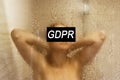 GDPR. A young woman is hidden behind the inscription General Data Protection Regulation.