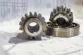 Gear and bearing lie on the technical drawing, concept of gear cutting production Royalty Free Stock Photo