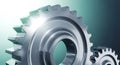 A close-up view of two shiny metal gears on a gradient background with bright lighting effects Royalty Free Stock Photo