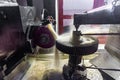 Gear grinding machine in operation, grinding of teeth of a wheel with oil cooling under pressure