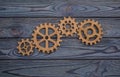 Gear wheels on a wooden background. Royalty Free Stock Photo