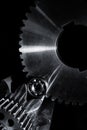 Gears and cogwheels set against black background Royalty Free Stock Photo