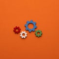 Gears on orange color background - Business mechanism concept, flat graphic resource for design
