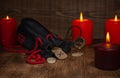 Gebo rune, a bag of runes, and a background of candles with selective focus. Royalty Free Stock Photo