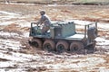 Gecko amphibious all terrain vehicle driving through muddy water