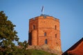 Gediminas' Tower in Vilnius, the remaining part of the Upper Castle, Lithuania with lithuanian flag on blue sky with Royalty Free Stock Photo