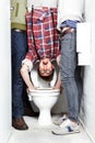 Geek, bully and students in a school toilet for abuse, fear or hazing of a victim in a bathroom stall. Portrait, dunk