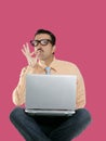 Geek man sit laptop computer ok positive gesture Royalty Free Stock Photo