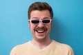 Geek retro caucasian man with funny mustache sunglasses with serious emotion on face