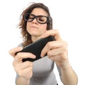 Geek woman playing with a smart phone Royalty Free Stock Photo