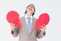 Geeky businessman crying and holding broken heart card Royalty Free Stock Photo