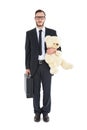 Geeky businessman holding briefcase and teddy