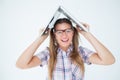 Geeky hipster holding her laptop over her head Royalty Free Stock Photo