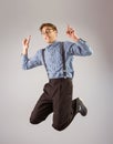 Geeky hipster jumping and pointing