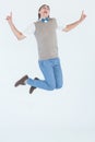 Geeky hipster jumping and smiling