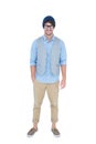 Geeky hipster looking at camera with hand in pocket