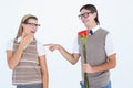 Geeky hipster offering red roses to his girlfriend Royalty Free Stock Photo