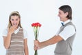 Geeky hipster offering red roses to his girlfriend Royalty Free Stock Photo