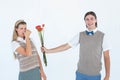 Geeky hipster offering red roses to his girlfriend Royalty Free Stock Photo