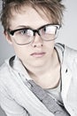 Geeky Looking Teenager against Grey Background Royalty Free Stock Photo