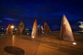 Geelong waterfront art structures resembling either fins or sails taken on a long exposure at twilight .