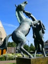 Statue of two prancing horses in a village square