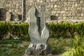 Khachkar from basalt carved as a donative to the monastery and installed in the Park near the stone wall, located around the monas Royalty Free Stock Photo