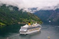 Geiranger, Norway - January 25, 2010: adventure, discovery, journey. Cruise ship in norwegian fjord. Passenger liner docked in por Royalty Free Stock Photo