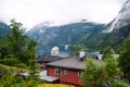 Geiranger, Norway - January 25, 2010: adventure, discovery, journey. Ship in norwegian fjord on cloudy sky. Ocean liner in village Royalty Free Stock Photo