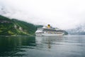 Geiranger, Norway - January 25, 2010: cruise ship in norwegian fjord. Passenger liner docked in port. Travel destination, tourism. Royalty Free Stock Photo