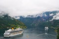 Geiranger, Norway - January 25, 2010: vacation, trip, wanderlust. Cruise ship in norwegian fjord. Passenger liner docked in port.