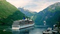 GEIRANGER, NORWAY - 16 JUN 2019: Time lapse clip of cruise ship being moored by crew in boat as smaller cruiseliner awaits its