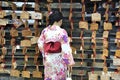Geisha in front of prayer tablets