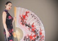 Geisha and giant fan against brown background Royalty Free Stock Photo